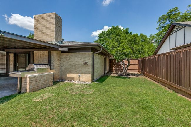 Fenced backyard with exterior kitchen | Image 32