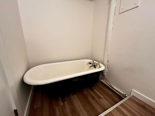 Bathroom with a soaking tub and wood finished floors | Image 7