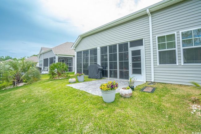 Back of property with a patio, a lawn, and a sunroom | Image 4