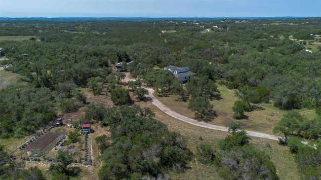 Aerial view of property's location with a heavily wooded area | Image 34