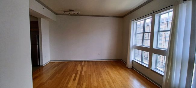 Open Living with Wood floors, Ornamental Molding and Large Window with Views | Image 27