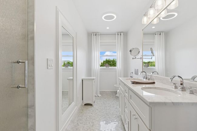 Bathroom featuring double vanity, tile patterned floors, recessed lighting, and toilet | Image 15