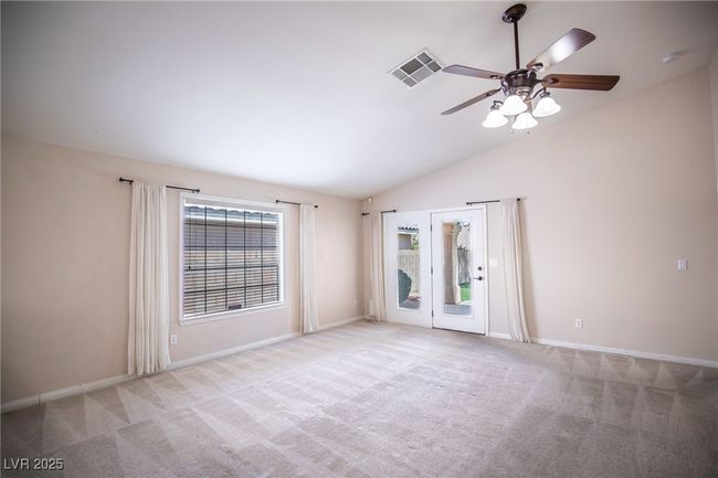 Unfurnished room with baseboards, carpet floors, and lofted ceiling | Image 13