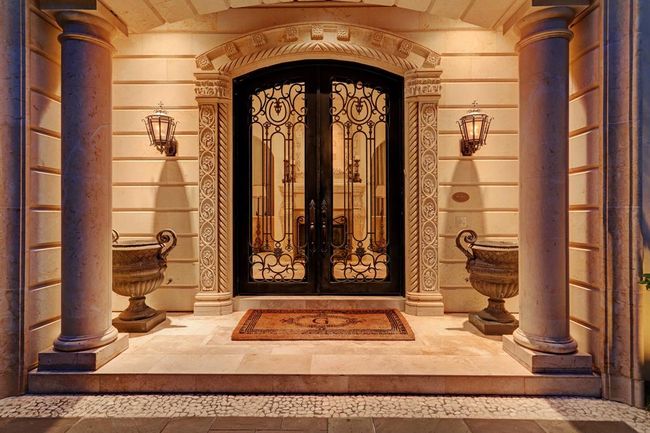 Grand entrance with Cantera doors and carved Limestone. | Image 2