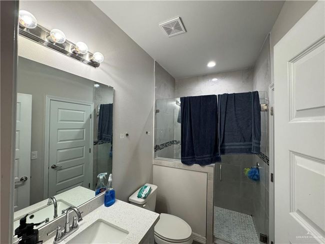 Bathroom featuring a shower stall, vanity, toilet, and recessed lighting | Image 5