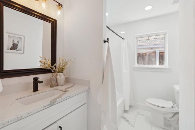 The two additional bedrooms share a beautifully updated hall bath. | Image 24