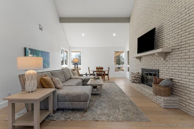 Formal living room with floor-to-ceiling brick fireplace | Image 28
