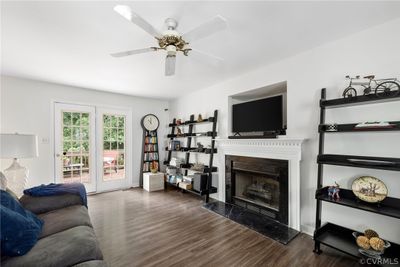 Vinyl flooring, ceiling fan, doors to deck and fresh paint. | Image 3