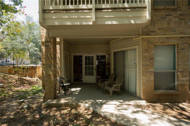 View of patio / terrace with a balcony and fence | Image 24