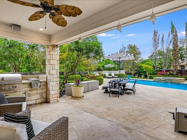 View of patio / terrace featuring a fenced backyard, a pool with connected hot tub, a grill, and area for grilling | Image 22