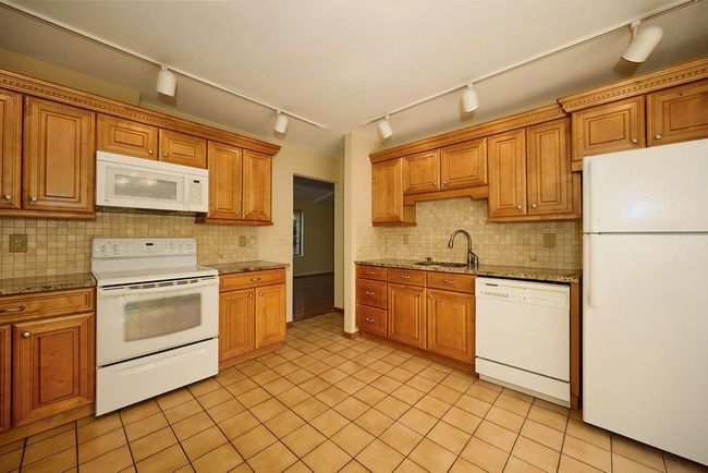 Kitchen with white appliances and track lighting | Image 6