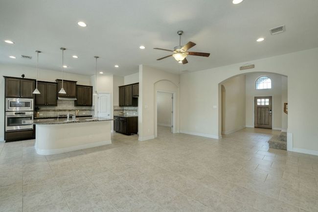 great room looking into kitchen and entry foyer. | Image 6