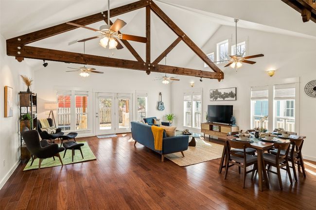 Living area with a ceiling fan, high vaulted ceiling, beam ceiling, and hardwood / wood-style flooring | Image 5
