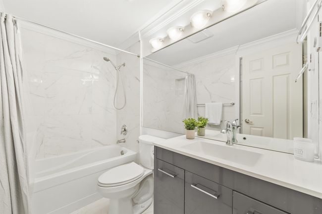 Full bathroom with toilet, shower / bath combo, crown molding, and vanity | Image 21