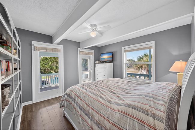 Bedroom featuring dark wood finished floors, a textured ceiling, and a ceiling fan | Image 29