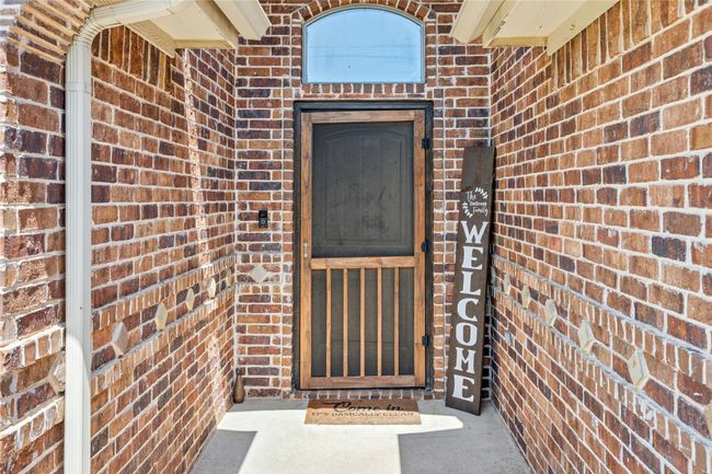 Feel instantly at home with the cozy charm of the front screen door | Image 6
