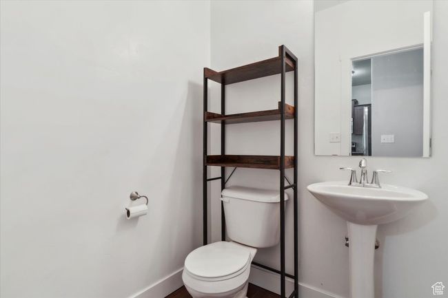 Bathroom featuring toilet and baseboards | Image 13