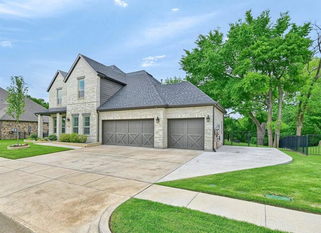 View of front of home with driveway, fence, an attached garage, a front yard, and roof with shingles | Image 5