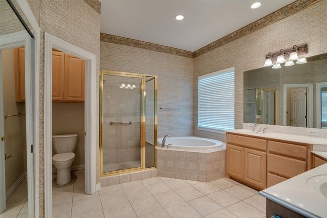 Bathroom with vanity, tile patterned flooring, a shower stall, a garden tub, and recessed lighting | Image 19