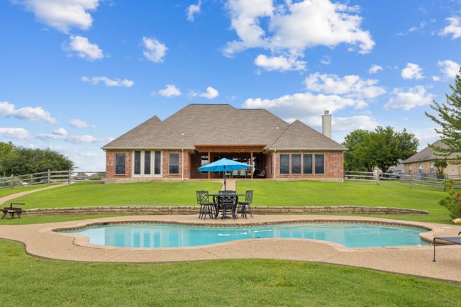 View of swimming pool with a patio area | Image 35