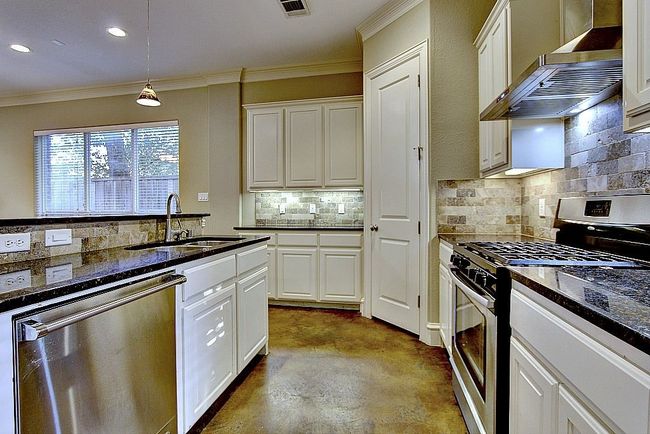 Kitchen Featuring Stainless Steel Aappliances and Backsplash | Image 13