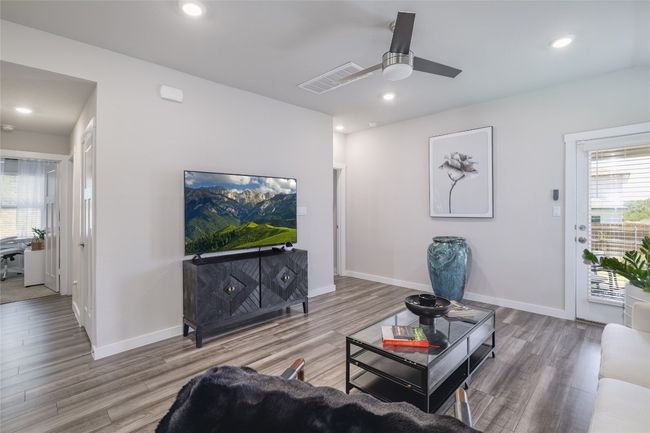 Living room with wood finished floors, a ceiling fan and recessed lighting | Image 7