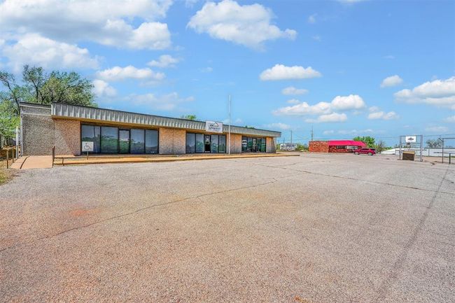 View of building exterior featuring uncovered parking | Image 9
