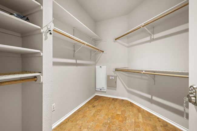 Walk in closet with built ins and secured door. | Image 24