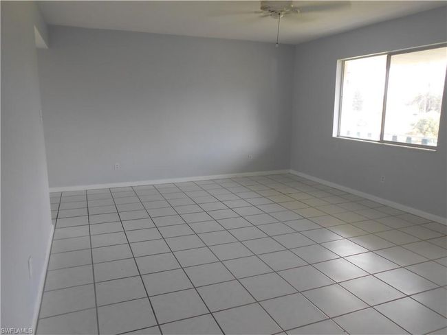 Unfurnished room with ceiling fan and baseboards | Image 5