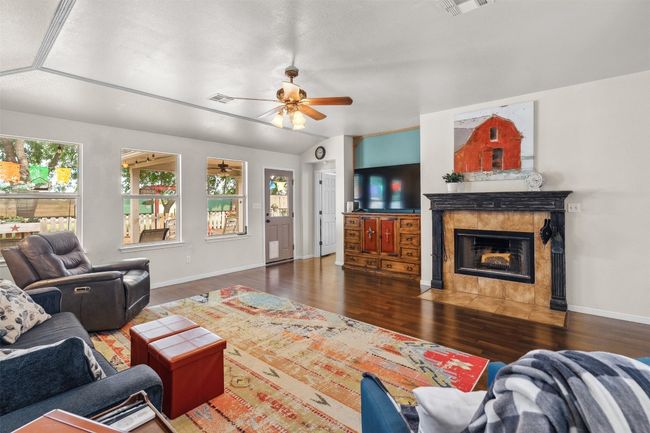 Large den with wood barning fireplace and views to the backyard | Image 21