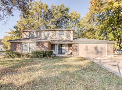 Front facade with a front yard and a garage | Image 1