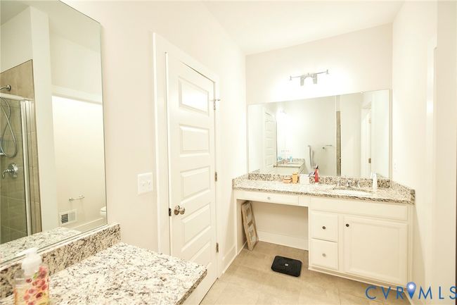 Full bath featuring a stall shower, vanity, and tile patterned floors | Image 13
