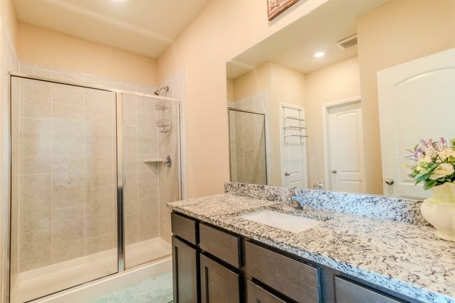 Bathroom with vanity and a shower with door | Image 24