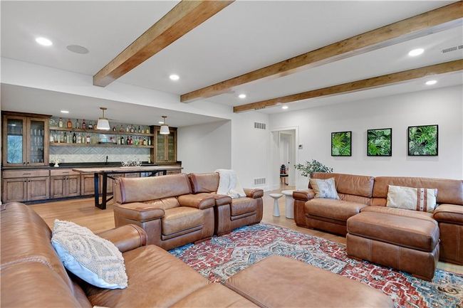 Living area featuring recessed lighting, light wood-style flooring, visible vents, and indoor wet bar | Image 45
