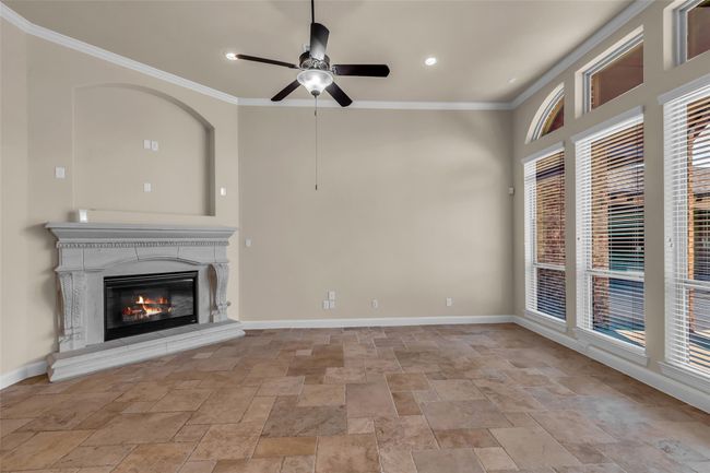 A handsome fireplace serves as a warm focal point, perfect for cozy gatherings and relaxing evenings. | Image 4