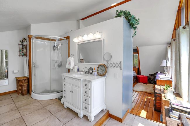 Ensuite bathroom featuring vanity, a stall shower, and tile patterned floors | Image 25