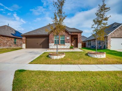 View of front of property with central air condition unit, a front lawn, and a garage | Image 1