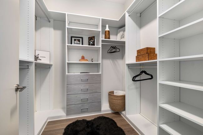 Expertly outfitted by California Closets, the spacious walk-in closet provides ample storage for everyday ease. | Image 31