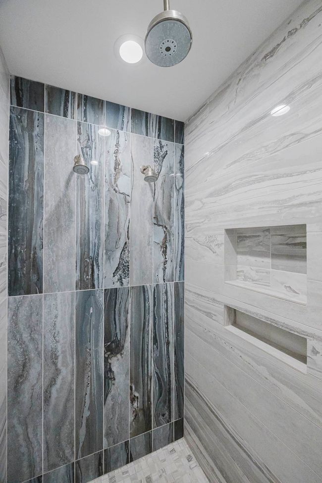 Full bathroom featuring a marble finish shower | Image 19