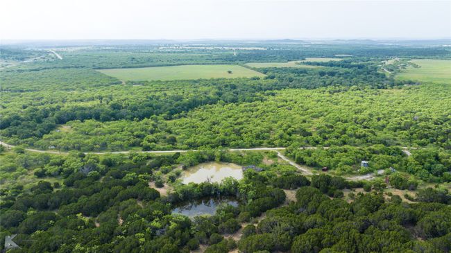 Drone / aerial view of a heavily wooded area and a large body of water | Image 20