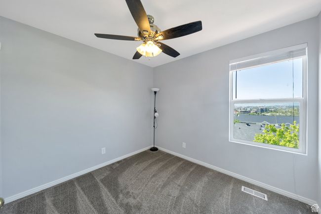 Bedroom with ceiling fan and views | Image 10