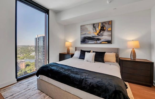 Bedroom with light wood-style floors and floor to ceiling windows | Image 9