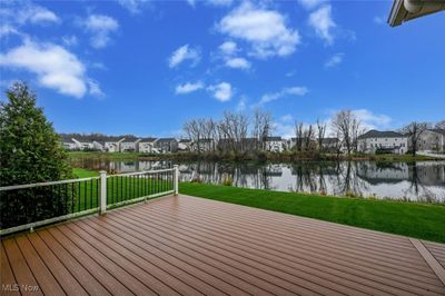 Deck with a water view and a lawn | Image 3