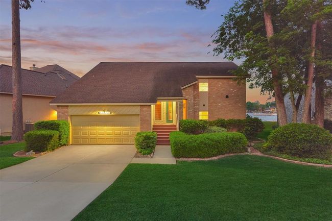 As night falls, the home transforms with elegant lighting that enhances its charm and curb appeal. | Image 5