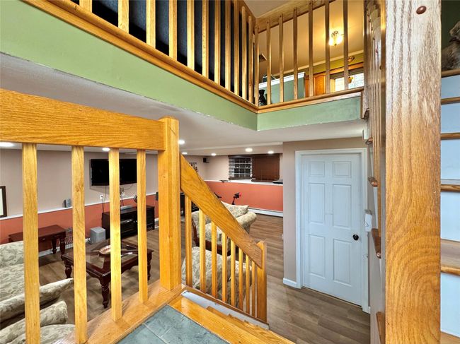 Stairs featuring a high ceiling and wood finished floors | Image 20
