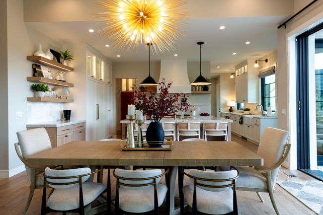 Dining room featuring light wood finished floors, recessed lighting, and a chandelier | Image 15
