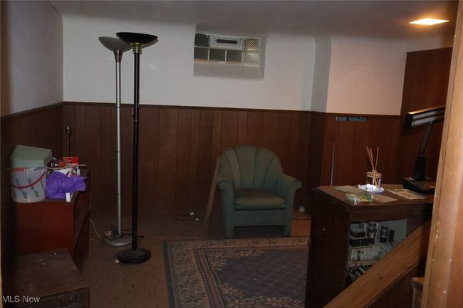 Sitting room featuring a wainscoted wall and wooden walls | Image 17