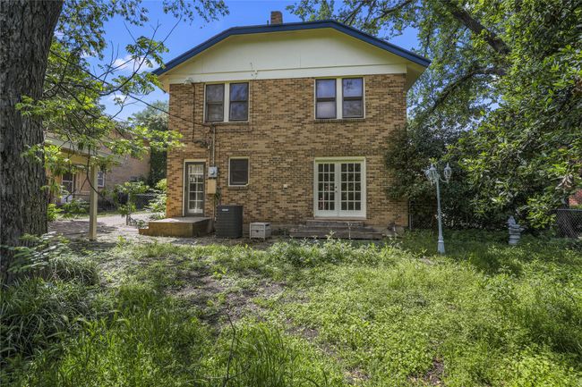 Back of house featuring brick siding, central air condition unit, and french doors | Image 16