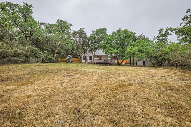 View of yard with a shed, a playground, an outbuilding, and a deck | Image 23