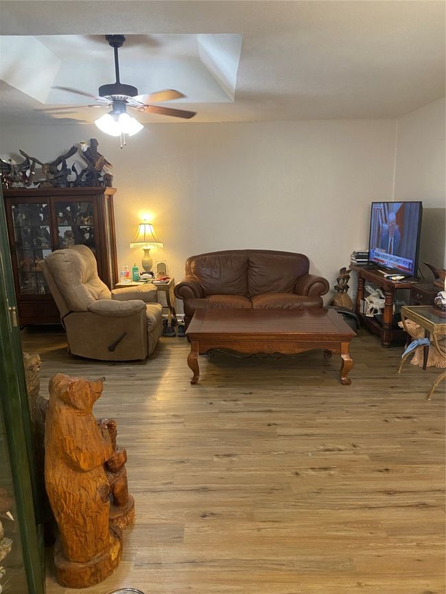 Living room featuring light wood-style floors and a ceiling fan | Image 5